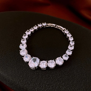 Detail of silver tennis bracelet with gradient zirconia and large oval center stone