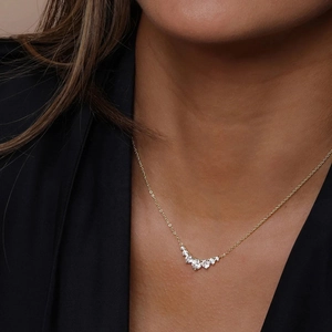 Elegant gold S925 silver necklace with five sparkling zircon stones on a female model
