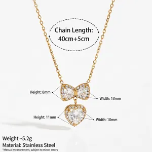 Golden stainless steel bow and heart pendant necklace set with sparkling zircon stones