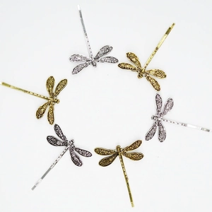 Vintage dragonfly hair clips set in gold and silver finish on a clean white background