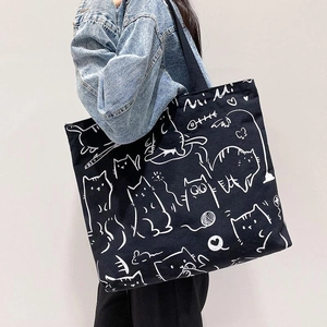 Large capacity canvas tote bag featuring white cartoon cat graffiti on black background