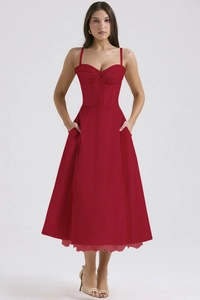 Detailed view of the red floral dress featuring waist tie design and thin shoulder straps