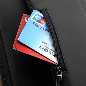 Macro detail of waterproof sling bag featuring a secure anti-theft zipper pocket for cards
