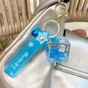 Polar bear liquid quicksand keychain charm with blue ocean theme on a silver bag
