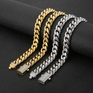 Detailed close-up of gold and silver hip hop cuban link chains with iced out box clasps