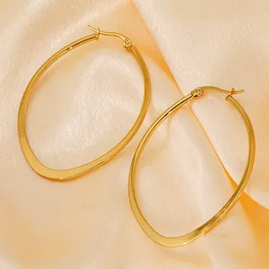 Minimalist 18K gold plated titanium oval hoop earrings on elegant silk background