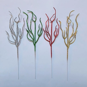 Detailed view of artificial Christmas branches with glitter in silver green red and gold colors