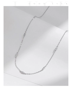 Detail of s925 sterling silver choker necklace with sparkling crystals on white paper