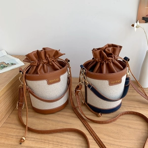 Retro canvas drawstring bucket bag with leather trim and contrast stitching for women