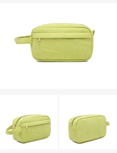 Detail view of light green corduroy makeup bag showing the side handle and zipper closure