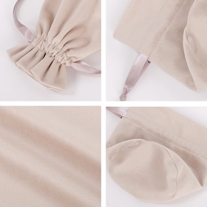 Detail view of beige velvet drawstring bag showing fabric texture and round bottom design