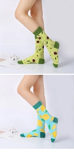 Detail of crew socks featuring knitted avocado and lemon patterns in green and blue