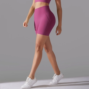 Close-up of rose pink high-waisted yoga shorts showing seamless design and lifting effect