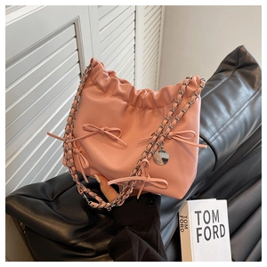 Detail of pink PU leather cloud bag featuring pleated design and elegant bow decoration