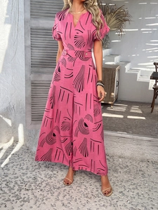 Close-up of pink V-neck jumpsuit with black geometric print and high waist belt detail