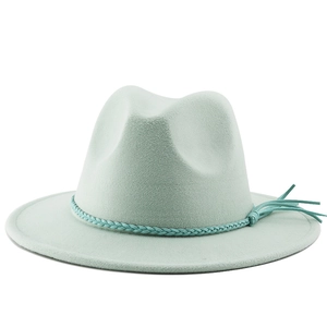 Detail of mint green fedora wool hat featuring a braided rope band and stylish tassel