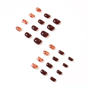Short press-on nail kit featuring deep wine red and amber marble patterns with gold foil