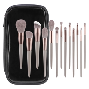 Close-up of 13 professional makeup brushes with rose gold ferrules and a black travel case