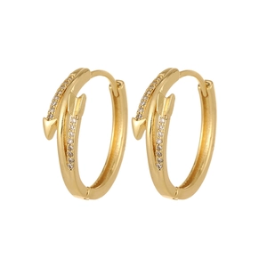 Detail of golden arrow hoop earrings with shimmering white micro zircon stones
