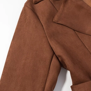 Detail of classic notched lapel and stitching on brown faux suede double-breasted coat