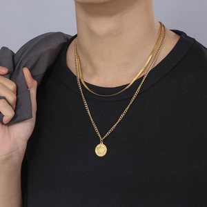 Double-layered 18k gold plated necklace with crown coin pendant on male model