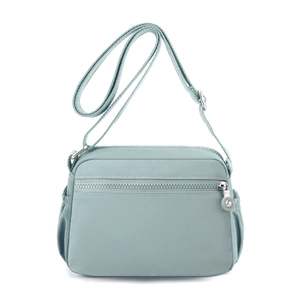 Waterproof nylon crossbody shoulder bag in mint green featuring adjustable strap and front pocket
