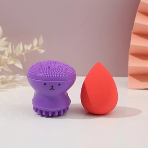 Close-up of a purple silicone octopus cleanser and a red teardrop makeup sponge set