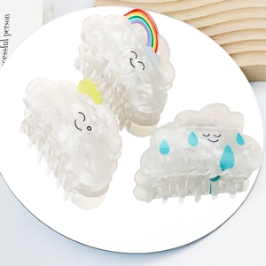 Cloud-shaped rainbow hair claws in marbled acetate with cute smiling faces