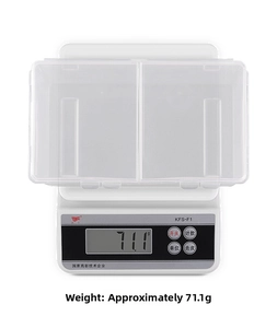 Detailed top view of a transparent two-compartment nail art storage box on a digital scale