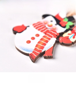 Close-up showing the material thickness and smooth back of wooden snowman ornaments