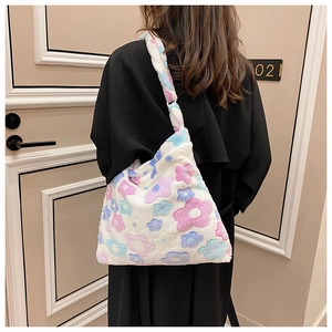 Detail view of white plush tote bag with colorful floral pattern on soft faux fur fabric