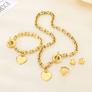 Chunky gold stainless steel jewelry set with heart pendants and T-bar clasp detail