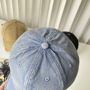Top view detail of washed cotton baseball caps showing stitching and eyelets in summer style