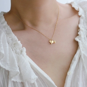 Detailed view of a gold-plated titanium steel necklace with a Corgi silhouette pendant