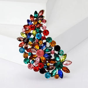 Detail of flower brooch featuring colorful rhinestones and gold metal plating