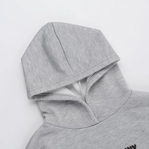 Detail of grey hooded sweatshirt showing soft fleece lining and high-quality knit texture