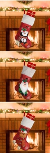 Close-up of three knitted Christmas stockings with Santa, reindeer and penguin designs