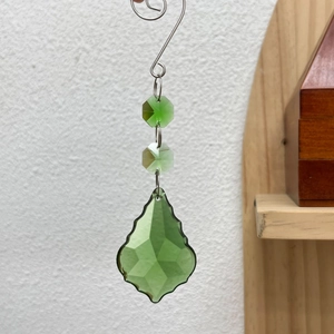 Close-up of a 50mm green maple leaf crystal suncatcher pendant with faceted beads