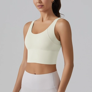 Detailed view of the V-shaped back and wide hem support on the cream sports bra