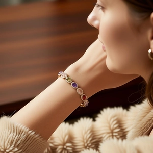 Close-up of vintage bracelet with colorful oval zircons and halo stones on wrist