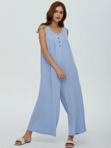 Detail of light blue striped sleeveless jumpsuit featuring chest button accents