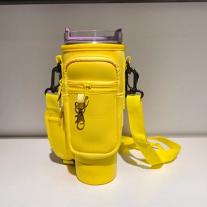 Detail of a bright yellow 40oz tumbler carrier bag with zipper pockets and shoulder strap