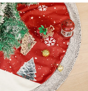 Detail of red burlap Christmas tree skirt with white snowflake prints and plush trim