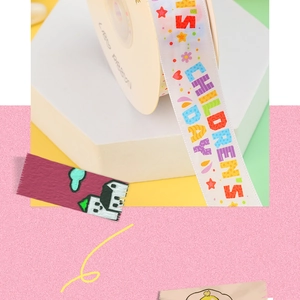 Macro shot of colorful Children's Day printed ribbon on a spool for gift decoration