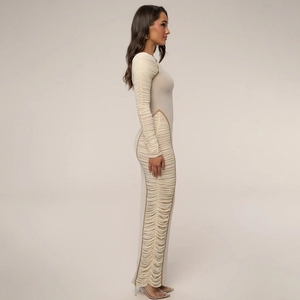 Detail view of ruched side seams on this beige bodycon dress with elegant draping effect