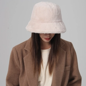 Close-up of pink plush bucket hat worn by model with brown coat for autumn style