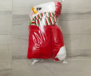 Detail of Christmas snowman countdown pendant with striped scarf in plastic packaging