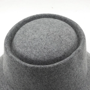 Macro shot of grey wool felt texture and circular flat top detail of the fisherman bucket hat