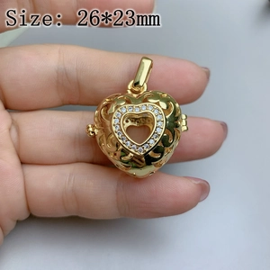 Macro detail of gold heart pendant with micro pavé crystals and intricate filigree pattern