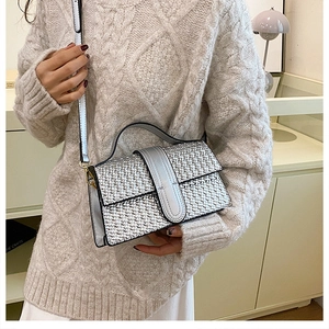 Close-up of silver woven texture shoulder bag with leather handle and luxury finish